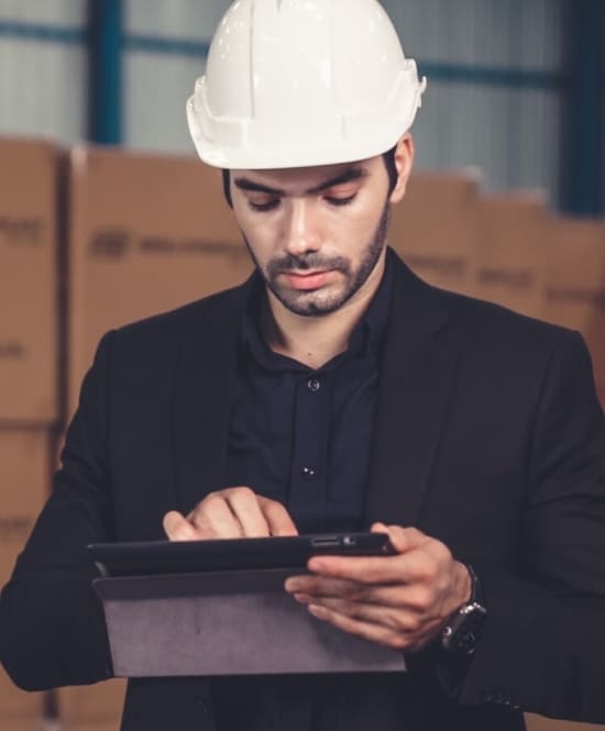 factory manager employer taking inventory with tablet